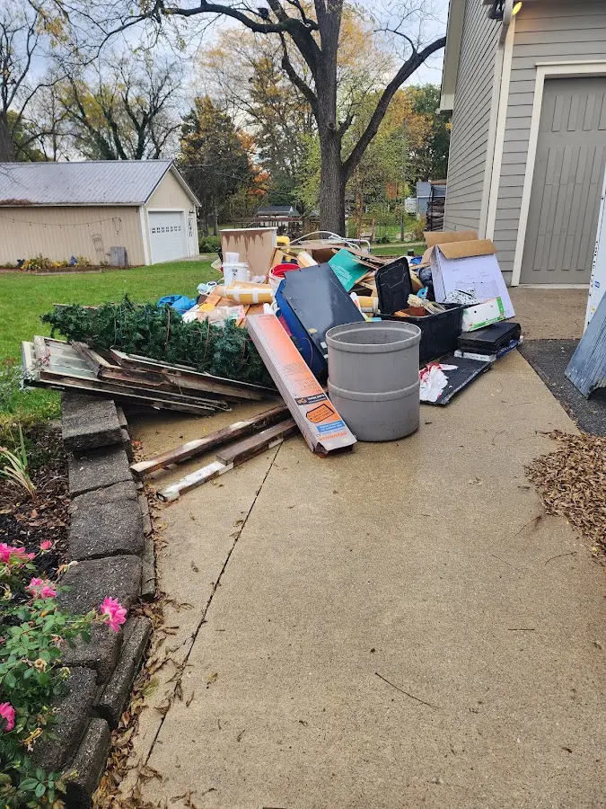 Dumpster being loaded with debris for 3 Yard Dumpster Rental in Tipton
